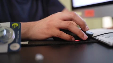 Hand Using Computer Mouse at Office Desk Beside Keyboard and Monitor 库存影片 333854710