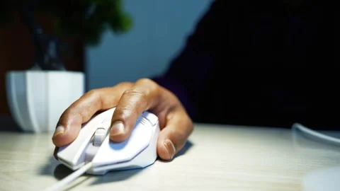 Hand using a computer mouse at an office desk, Close-up of a hand using a w.. Video stock 346462803