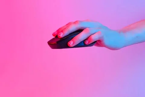Hand using computer mouse on pink and purple background Stock Photos