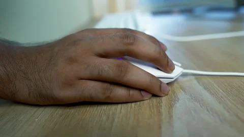 Hand using a computer mouse on a wooden desk Table Stock Footage 315981072
