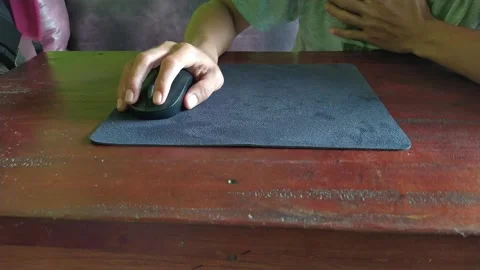 Hand Using Computer Mouse on Wooden Desk Stock Footage 328523704