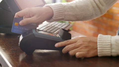 Hand using credit card for payment at cafe restaurant, cashless technology Stock Footage 147162564