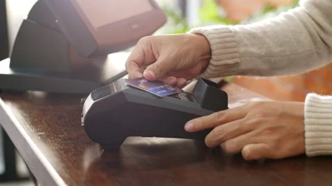 Hand using credit card for payment at cafe restaurant, cashless technology Stock Footage 147162799