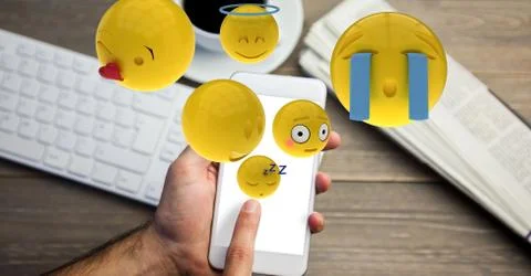 Hand using emojis on smart phone Stock Photos