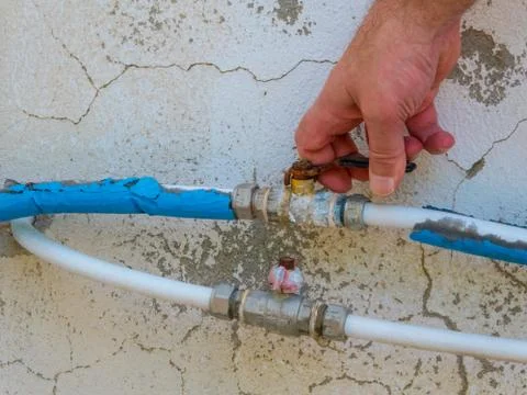 Hand using a faucet outside Stock Photos