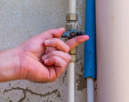 Hand using a faucet outside Stock Photos
