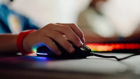 Hand using gaming mouse with colorful light in background during gaming session Stock Footage 344690439
