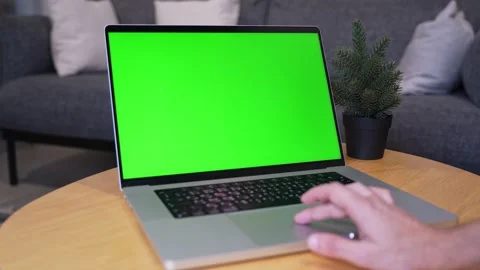 Hand using green screen laptop in living room Stock Footage 336763912