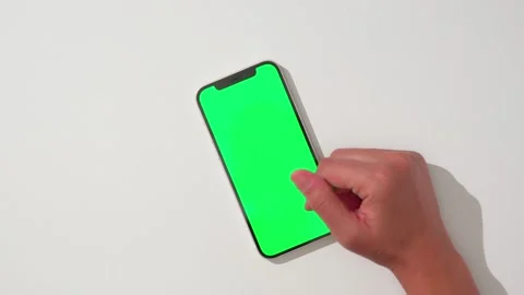 Hand using green screen smartphone, scroll and double tap Stock Footage 284266703