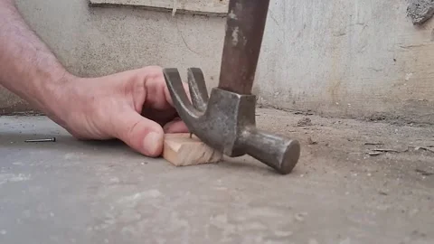 Hand using hammer to level concrete surface. Construction worker installing Stock Footage 340922449