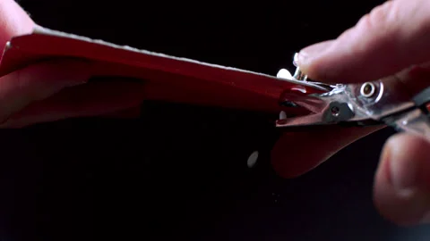 Hand Using Hole Puncher On Thick Paper In Slow Motion Stock Footage 267759274