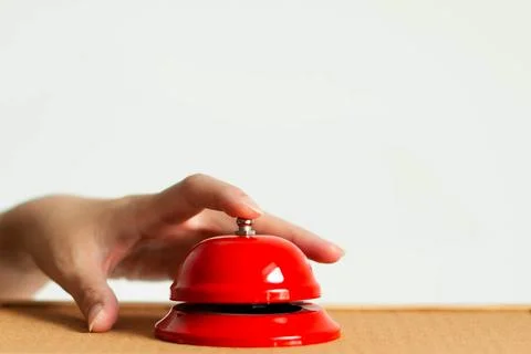 A hand using index finger pressing the bell button of red vintage style han.. Stock Photos