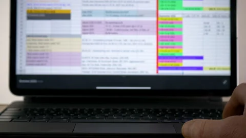 A hand using a keyboard to scroll through spreadsheet data. Stock Footage 262062977