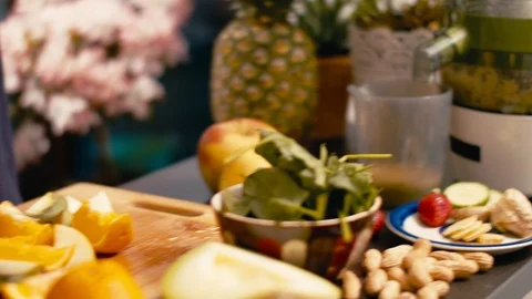 Hand using a kitchen aid to make vegan healthy juice Stock Footage 107810740