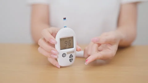 Hand using lancet pen on finger with Blood drop glucose testing or Diabetes.. Stock Footage 334786815
