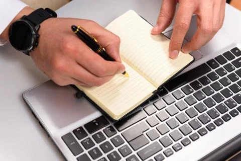Hand using laptop and write note inspire idea on office desk Stock Photos