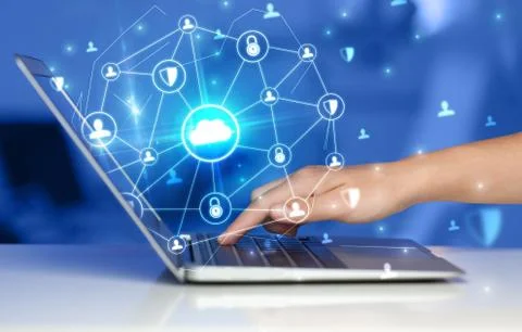 Hand using laptop with centralized linked cloud system concept Stock Photos