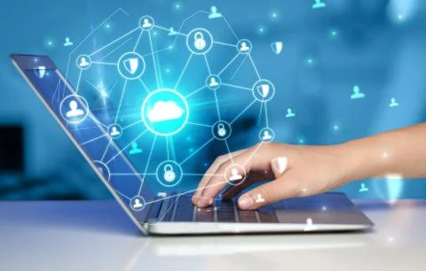 Hand using laptop with centralized linked cloud system concept Stock Photos