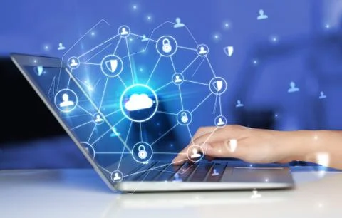 Hand using laptop with centralized linked cloud system concept Stock Photos