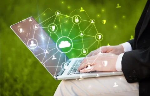 Hand using laptop with centralized linked cloud system concept Stock Photos