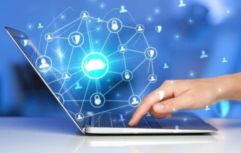 Hand using laptop with centralized linked cloud system concept Stock Photos