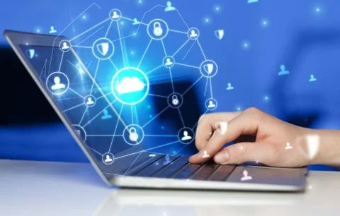 Hand using laptop with centralized linked cloud system concept Stock Photos