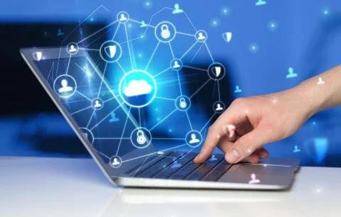 Hand using laptop with centralized linked cloud system concept Stock Photos