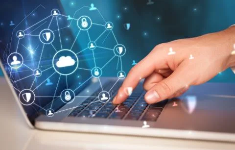 Hand using laptop with centralized linked cloud system concept Stock Photos