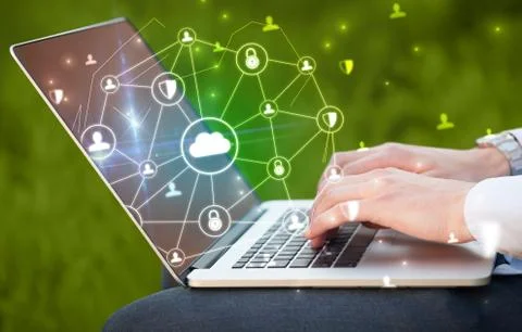 Hand using laptop with centralized linked cloud system concept Stock Photos