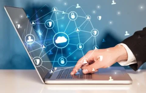 Hand using laptop with centralized linked cloud system concept Stock Photos