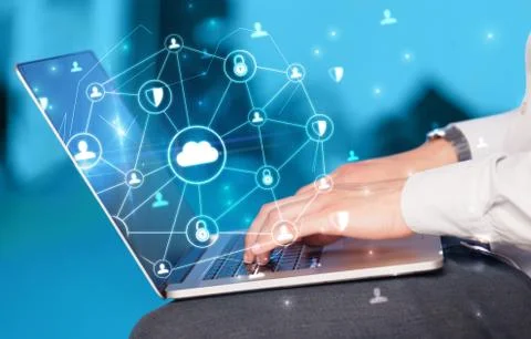 Hand using laptop with centralized linked cloud system concept Stock Photos