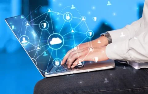 Hand using laptop with centralized linked cloud system concept Stock Photos