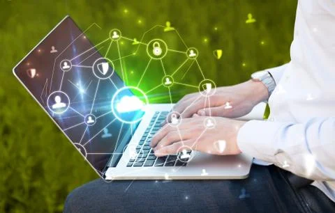 Hand using laptop with centralized linked cloud system concept Stock Photos