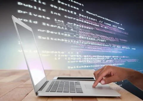 Hand using laptop with coding text Stock Photos