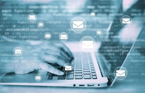 Hand using laptop with communication icons, letter icon, email icons, and new Foto stock
