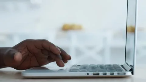 Hand using laptop computer on desk in bright office 写真素材