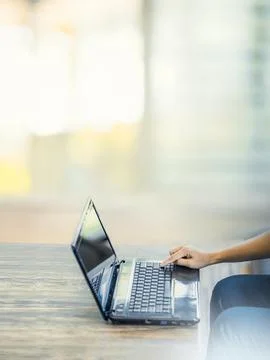 Hand using laptop in home office. Stock Photos