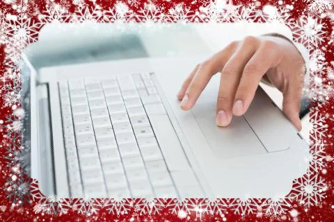 Hand using laptop at office desk against snow Illustrazione stock