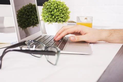Hand using laptop Stock Photos