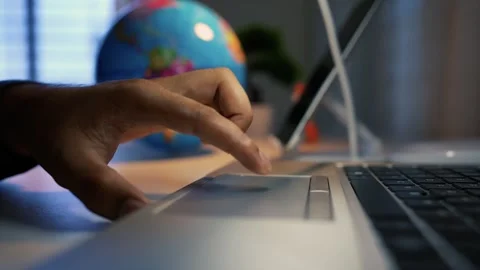 Hand Using Laptop Touchpad with Globe in Background Stock Footage 316745017