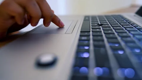 Hand Using Laptop Touchpad with Illuminated Keyboard Stock Footage 315982504