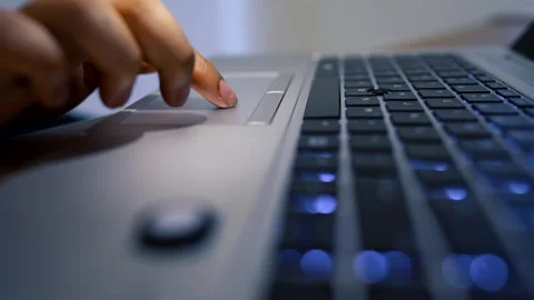 Hand Using Laptop Touchpad with Illuminated Keyboard Stock Footage 315982522