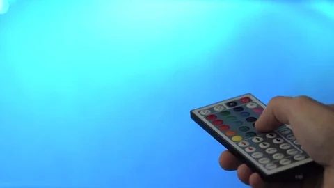 Hand using a LED Light remote control, closeup, changing colors Stock Footage 85241051