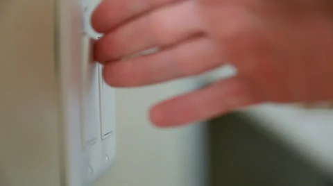 Hand using light switches Stock Footage 32942182
