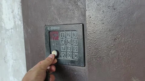 Hand Using a Magnetic Key Fob to Unlock an Intercom Door Stock Footage 314999038