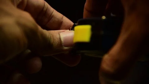 Hand using measuring tape on black background Stock Footage 84938607