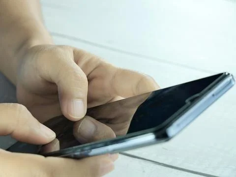 Hand using mobile phone, insurance or financial business concept. Stock Photos