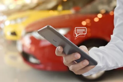Hand using mobile phone typing, with chat icons. Social media and technology  Stock Photos