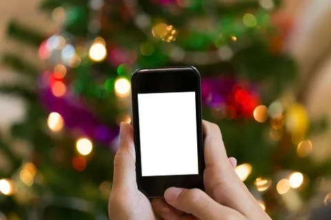 Hand using mobile smart phone with colorful light celebration background Fotos Stock