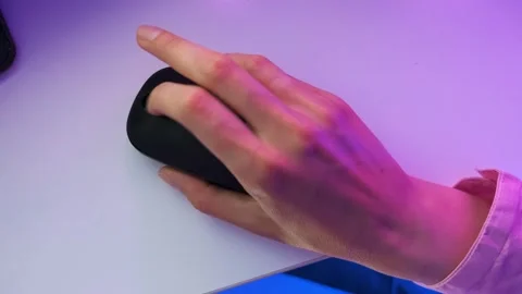 Hand using the mouse clicking the left and right buttons under neon light Stock Footage 243846058